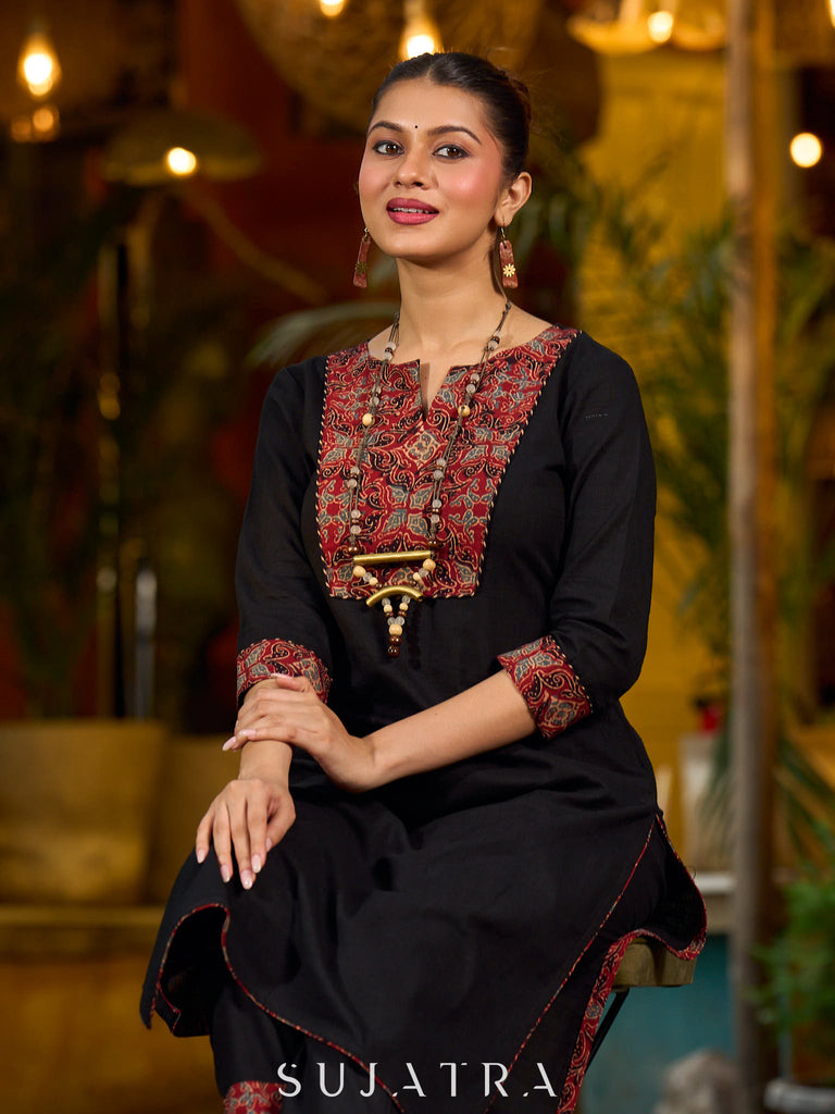 elegant black cotton kurta with beautifully crafted ajrakh panel and subtle stripe piping accents