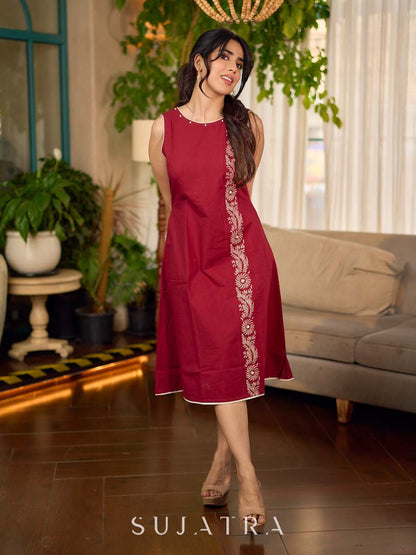 Maroon block printed sleeveless dress with hand block printed floral side panel, off-white accents, and pearl embellishments for a refined, elegant look.