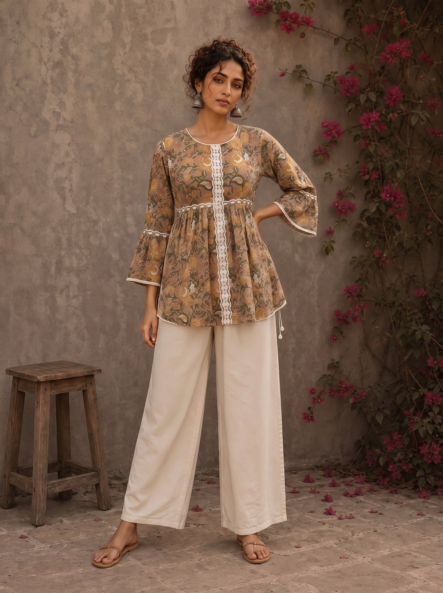 Romantic peach Jaipur floral top adorned with scalloped lace, gathered sleeve hems, and playful tie-knot accents.