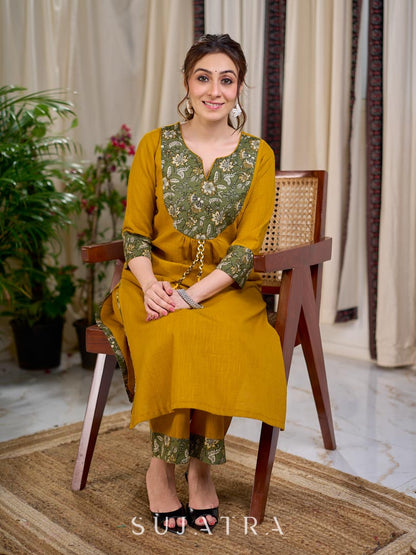 Vibrant Mustard Cotton Kurta with Olive Floral Print Yoke and Statement Tassel Embellishment