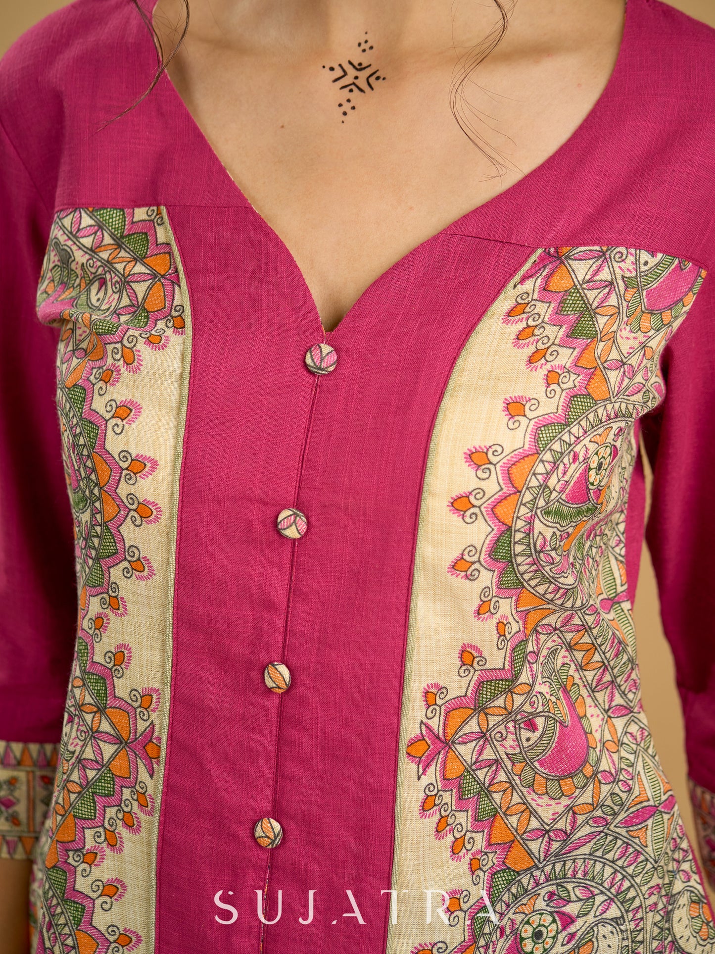 Madhubani print add charm to this magenta cotton top.