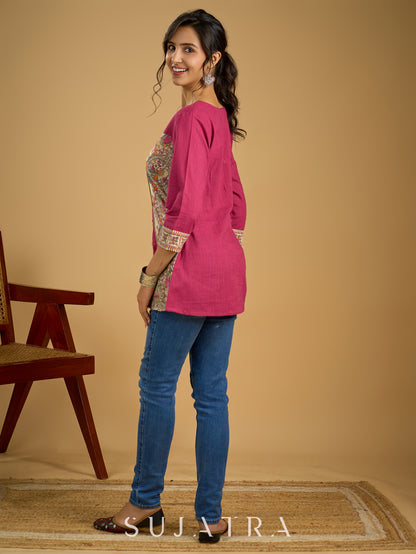 Madhubani print add charm to this magenta cotton top.