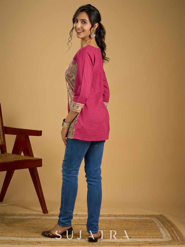 Madhubani print add charm to this magenta cotton top.