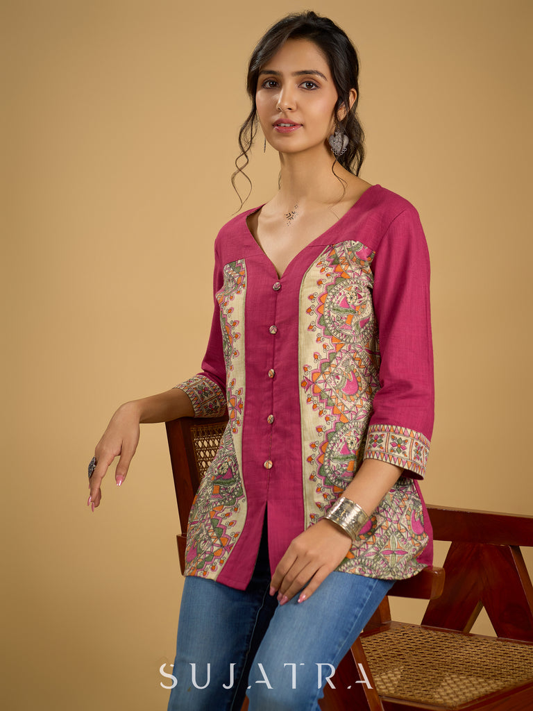 Madhubani print add charm to this magenta cotton top.