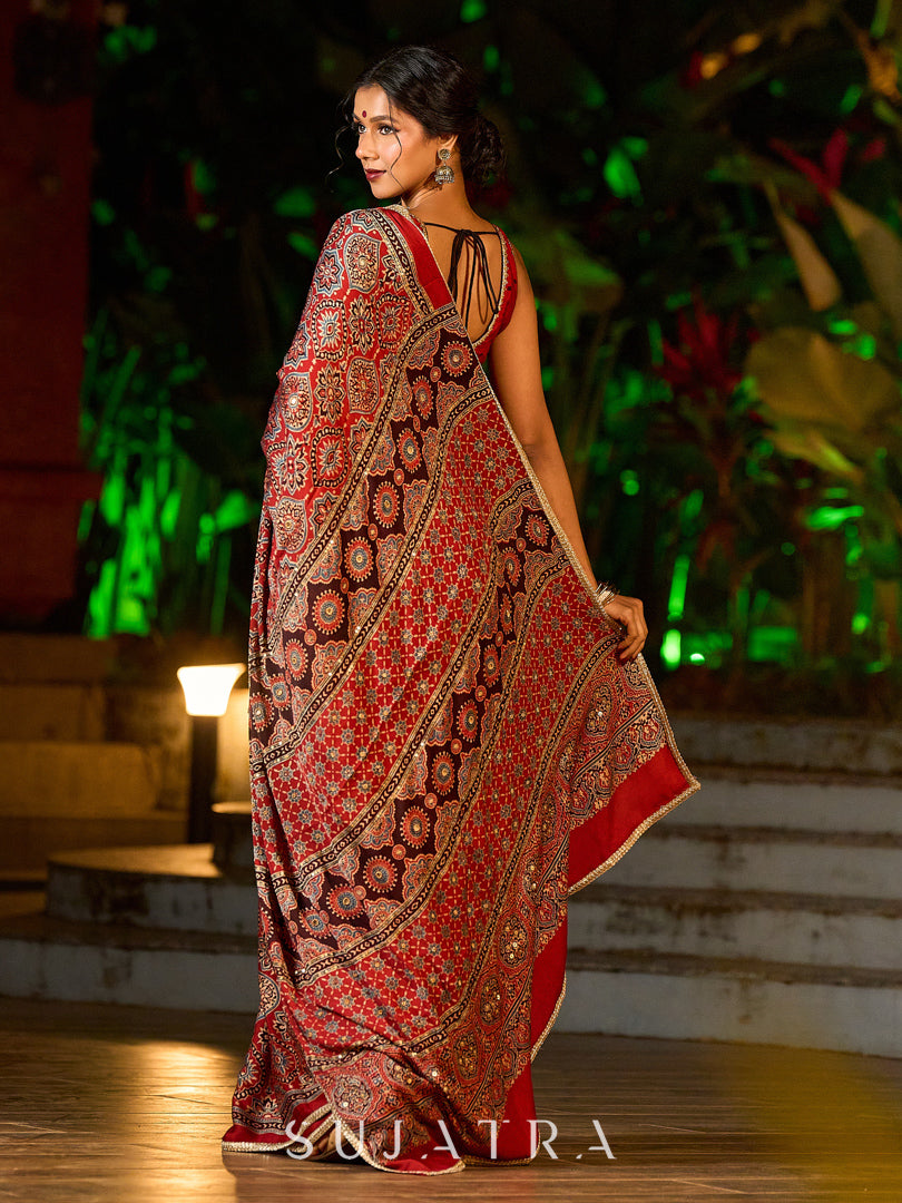 Striking Maroon Modal Silk Saree with Traditional Ajrakh Print & Contrast Gold Lace Detail & Hand Embroidered Pallu