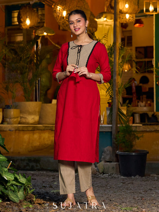 Elegant red kurta featuring a V-shaped striped neck panel