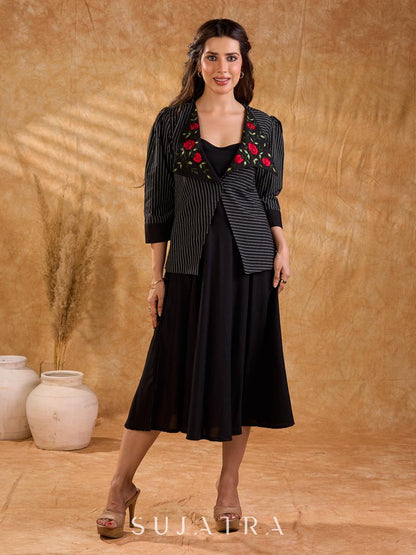 Exquisite black Ikat jacket with offset collar flaps and detailed red floral vine embroidery, delivering a sculpted, high-impact silhouette with refined presence for corporate styling.
