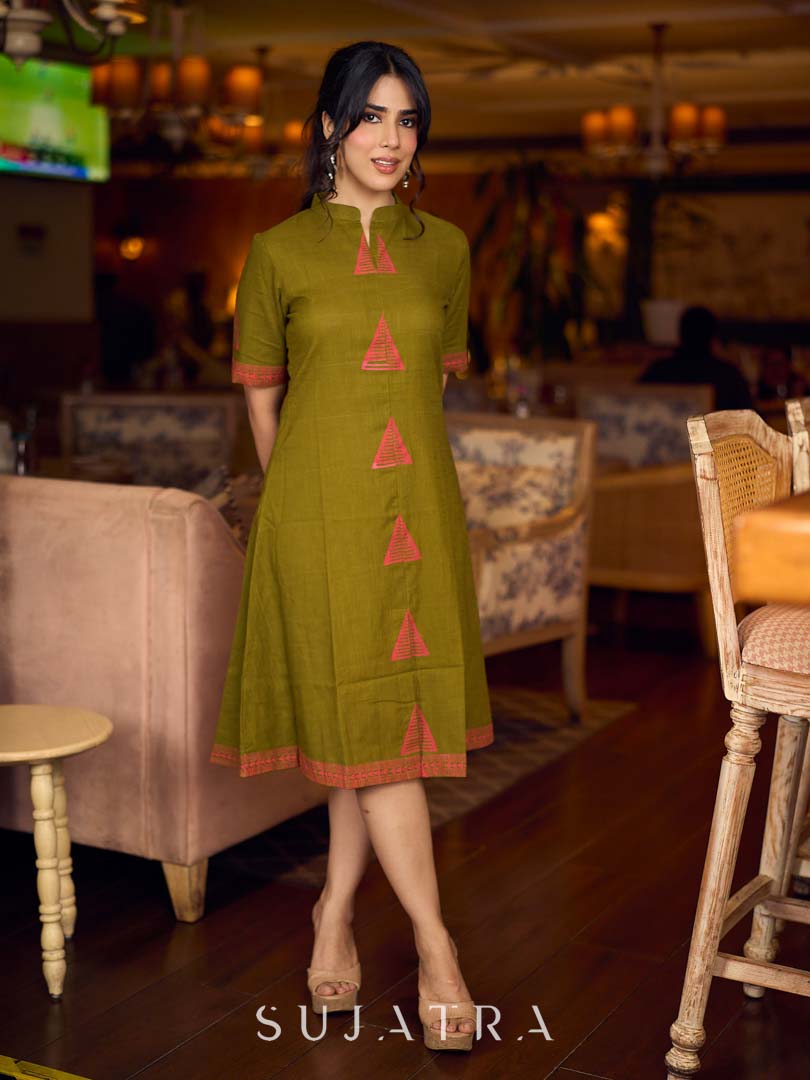 Gorgeous olive dress with pink abstract triangle hand block prints placed at the centre, sleeves, and back, featuring a mandarin collar and half sleeves for a refined, contemporary look.