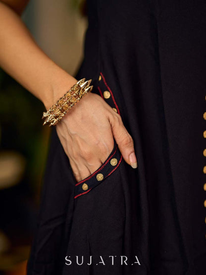 Black bias-cut block print halter dress with a red jaal hand block printed front panel, golden print detailing, and red accents for a striking, elegant statement look.