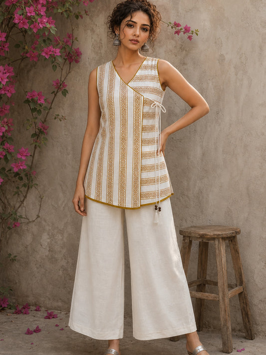 Charming white and mustard sleeveless wrap top featuring a distinctive Block print pattern, elegant mustard piping, and a graceful, contemporary, artisan-inspired tailored silhouette.