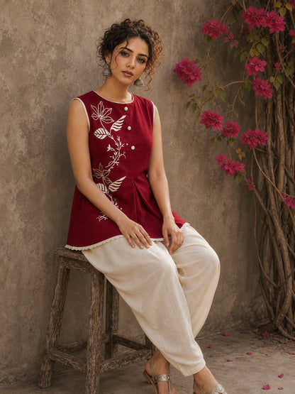 Charming red hand block print top showcasing elegant floral motifs, a contemporary pleated silhouette, and refined detailing, blending artisanal craftsmanship with effortless everyday style.