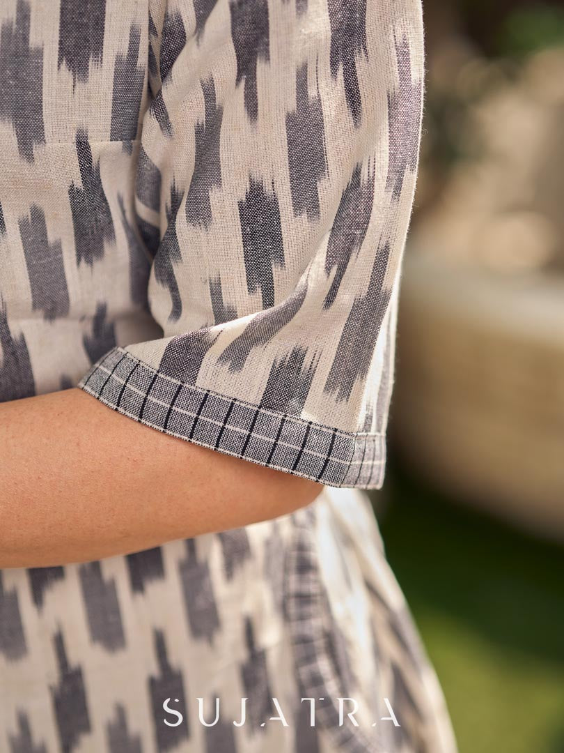 Modern white and grey Ikat shirt dress elevated with an asymmetrical checkered Ikat collar and contrast black accents.
