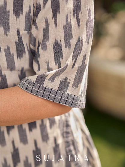 Modern white and grey Ikat shirt dress elevated with an asymmetrical checkered Ikat collar and contrast black accents.