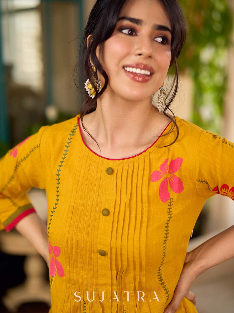 Mustard block printed pintuck dress with hand block red and pink vine floral motifs, accented with red and olive details for a rich, elegant look.