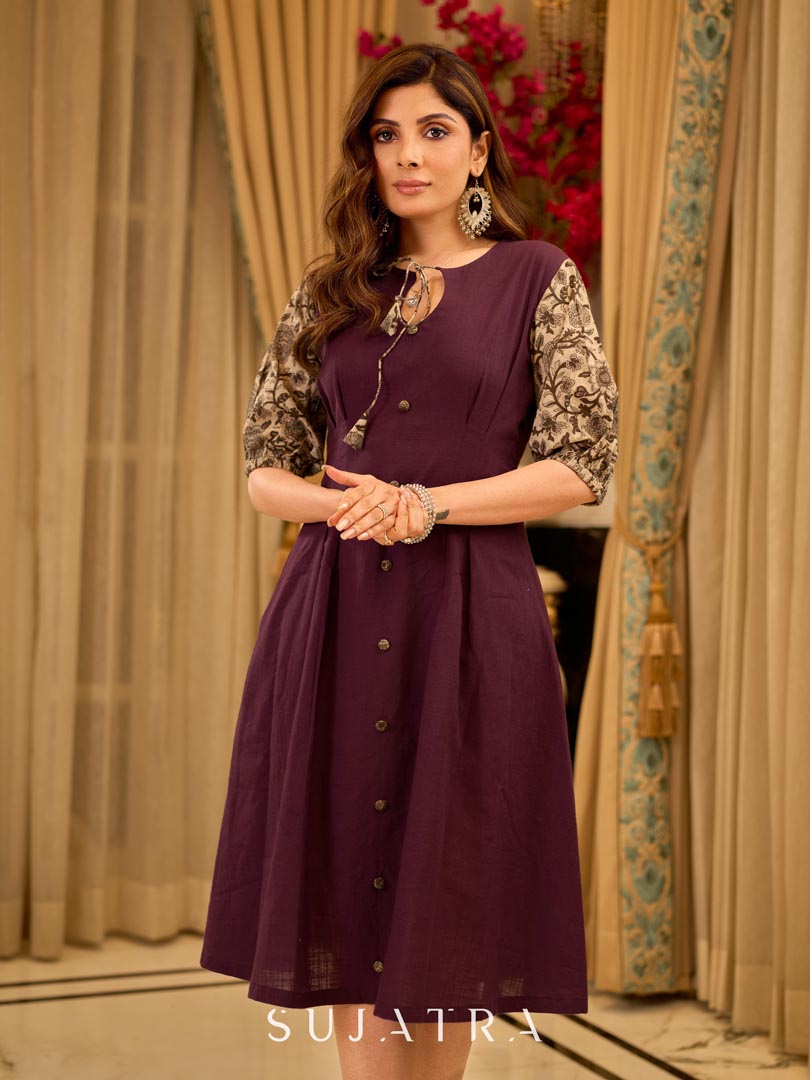 Playful purple cotton dress showcasing floral puff sleeves and box pleats released from the dart for soft volume and flow
