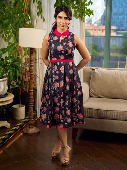 Elegant black Kalamkari dress featuring blooming florals and contrasting pink detailing for refined charm.