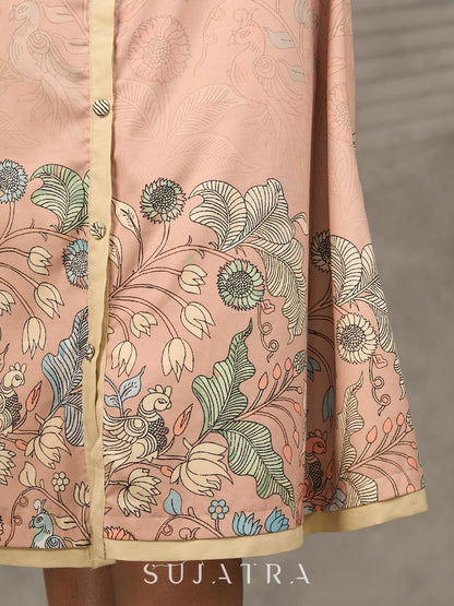 Peach Kalamkari-inspired shirt dress with soft beige accents.
