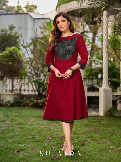 Chic maroon dress featuring a contrasting teal neck patch with charming Peter Pan collar details