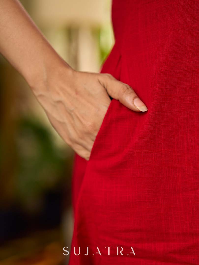 Vibrant red sleeveless dress with a bold off-white floral hand block print at the hem and clean off-white edging for a striking, handcrafted-inspired finish.