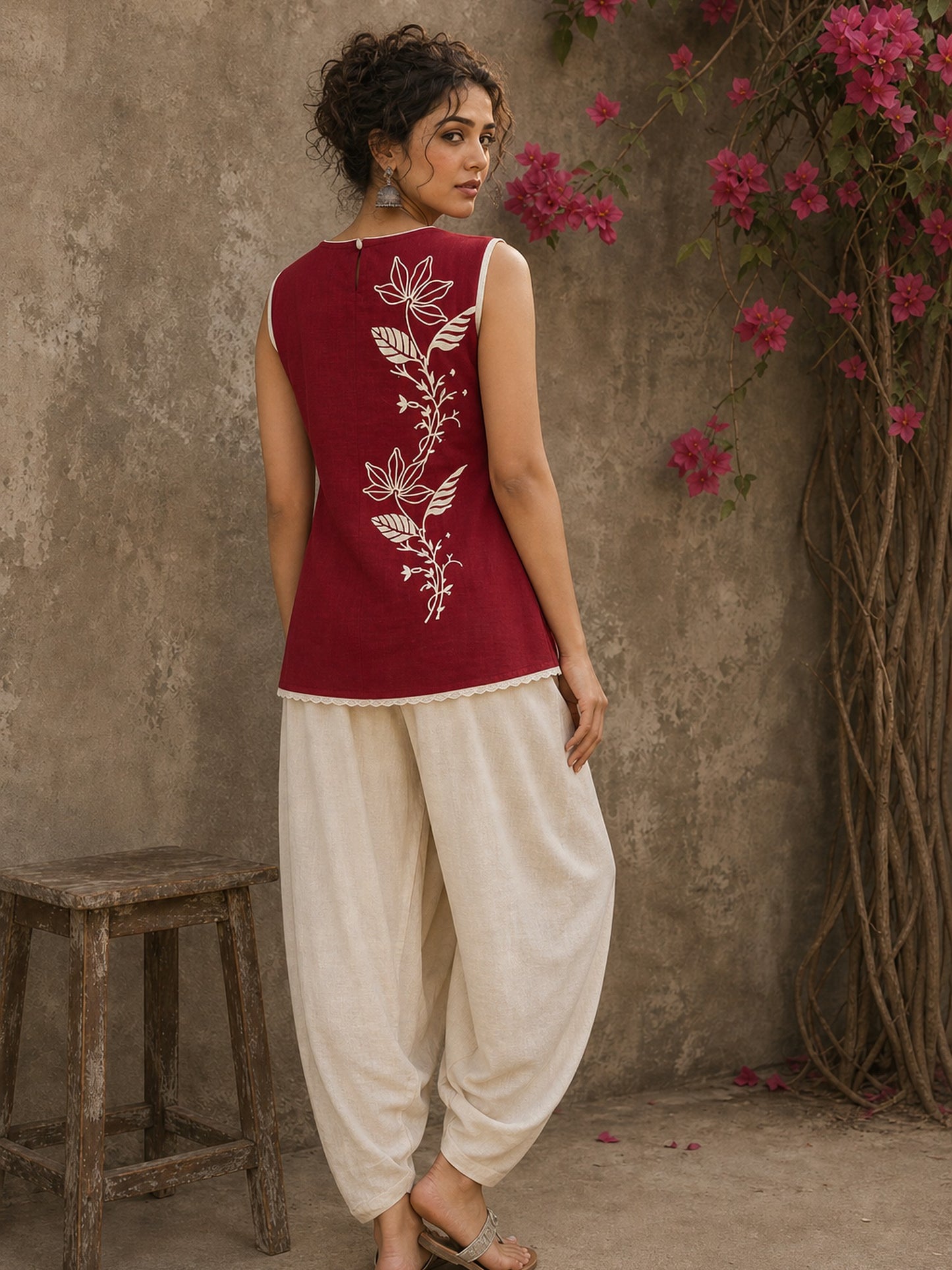 Charming red hand block print top showcasing elegant floral motifs, a contemporary pleated silhouette, and refined detailing, blending artisanal craftsmanship with effortless everyday style.