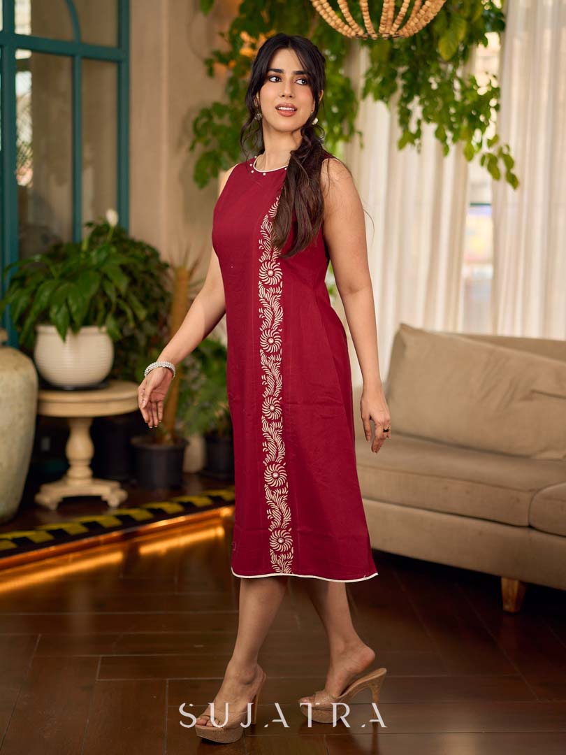 Maroon block printed sleeveless dress with hand block printed floral side panel, off-white accents, and pearl embellishments for a refined, elegant look.