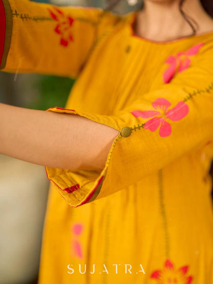 Mustard block printed pintuck dress with hand block red and pink vine floral motifs, accented with red and olive details for a rich, elegant look.