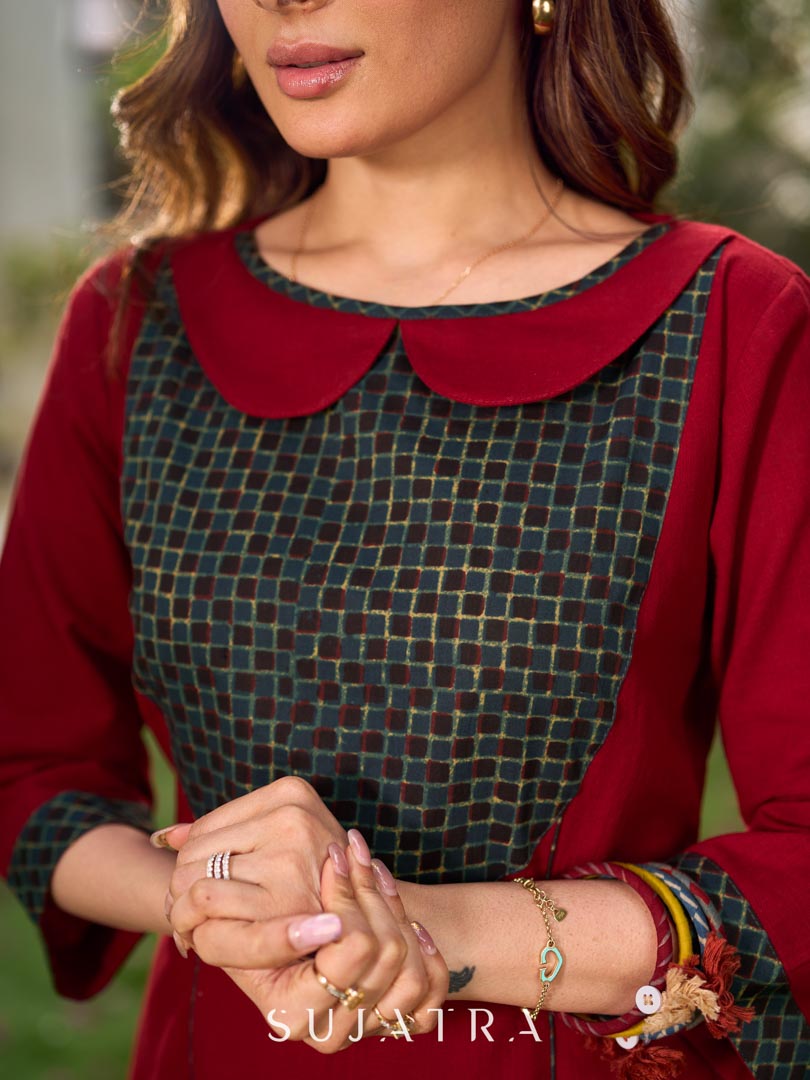 Chic maroon dress featuring a contrasting teal neck patch with charming Peter Pan collar details