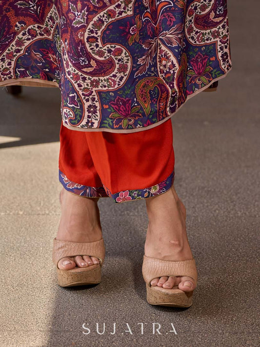 Stylish orange straight pants in soft rayon, accented with a vibrant blue printed border.