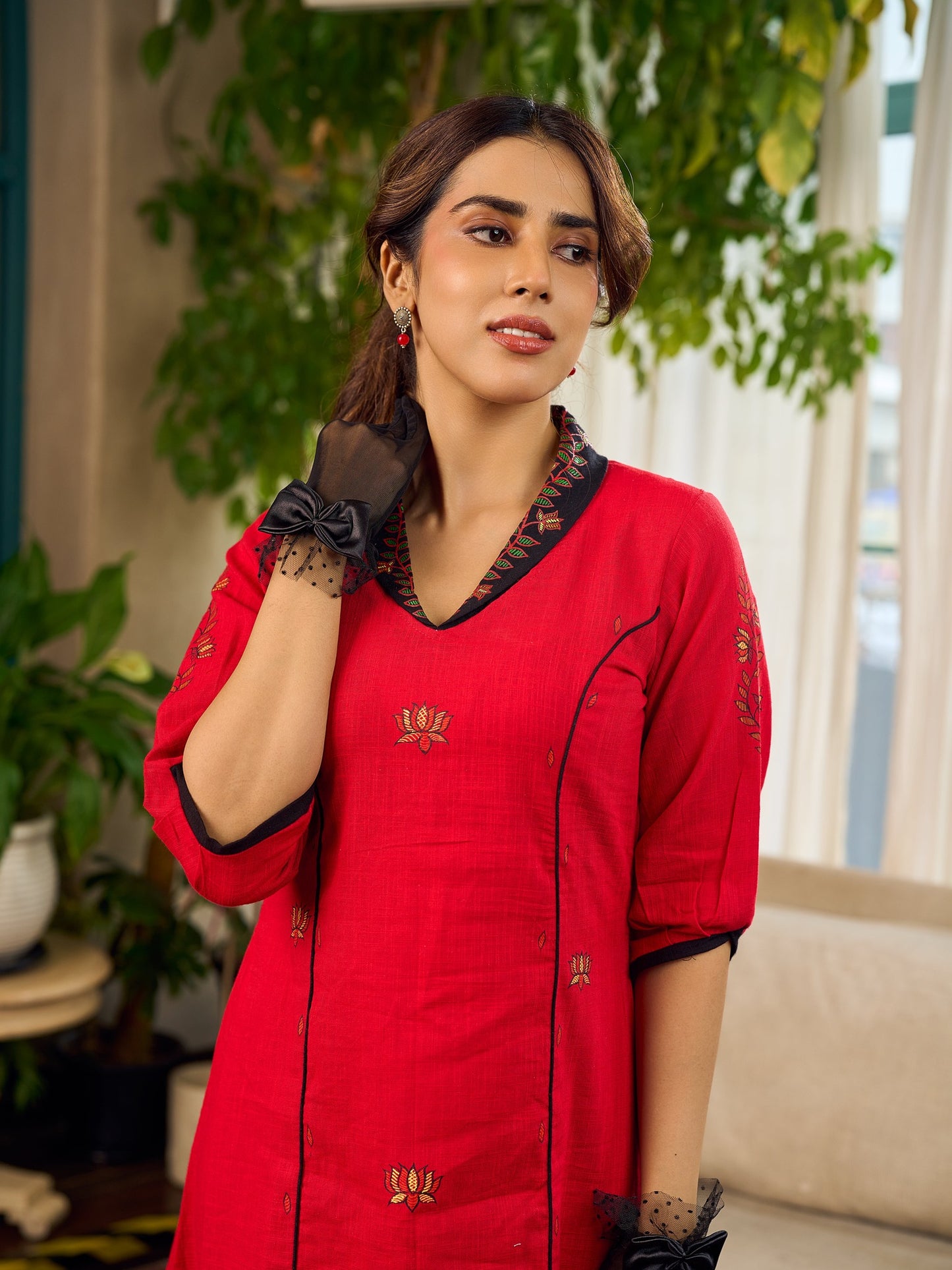 Elegant red dress featuring delicate, hand-painted Madhubani lotus motif detailing.