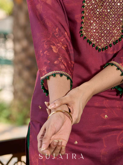 Exquisite deep burgundy printed kurta with intricate neck panel embroidery, delicate green beads, and refined green highlights.