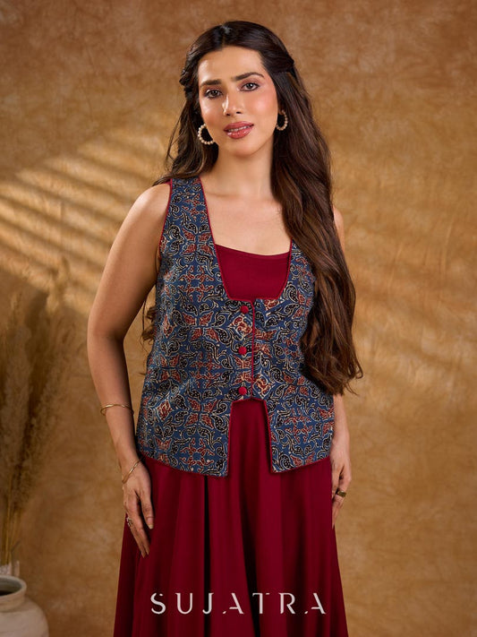 Handcrafted Ajrakh sleeveless jacket featuring front flaps, maroon detailing, breathable fabric, and a contemporary ethnic fusion appeal.