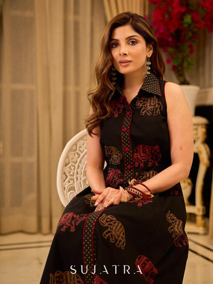 Statement black sleeveless shirt dress showcasing elephant-inspired prints and polka dots, highlighted with maroon accents.