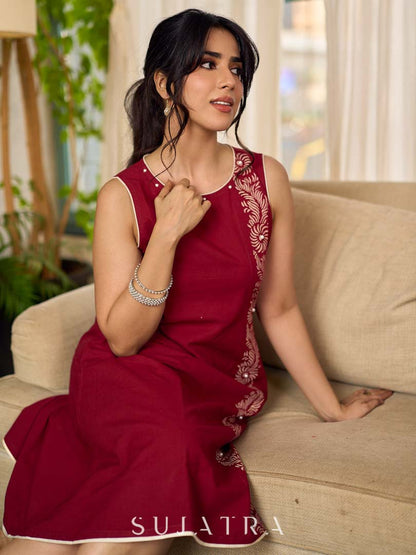 Maroon block printed sleeveless dress with hand block printed floral side panel, off-white accents, and pearl embellishments for a refined, elegant look.