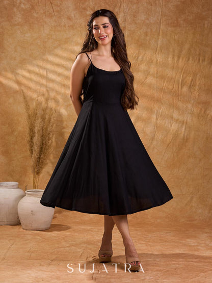 Fluid black rayon slip dress with a flattering bias silhouette, featuring a smooth fall, gentle movement, and a refined, understated appeal.