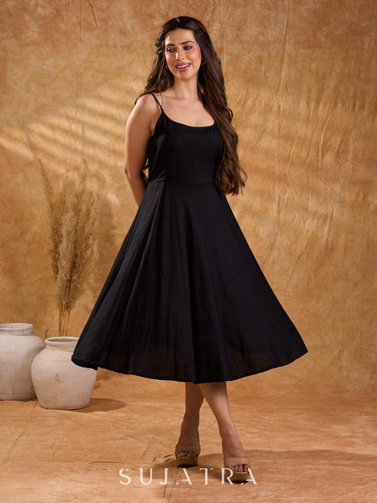 Fluid black rayon slip dress with a flattering bias silhouette, featuring a smooth fall, gentle movement, and a refined, understated appeal.