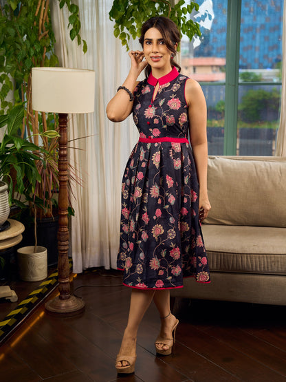 Elegant black Kalamkari dress featuring blooming florals and contrasting pink detailing for refined charm.