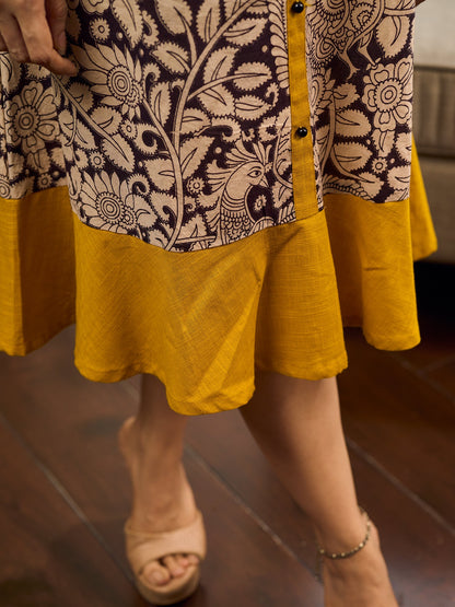 Heritage Kalamkari dress with elegant mustard accents and black pearl embellishments.