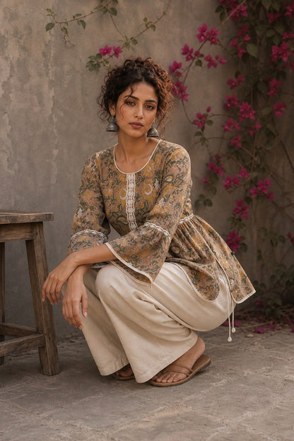 Romantic peach Jaipur floral top adorned with scalloped lace, gathered sleeve hems, and playful tie-knot accents.