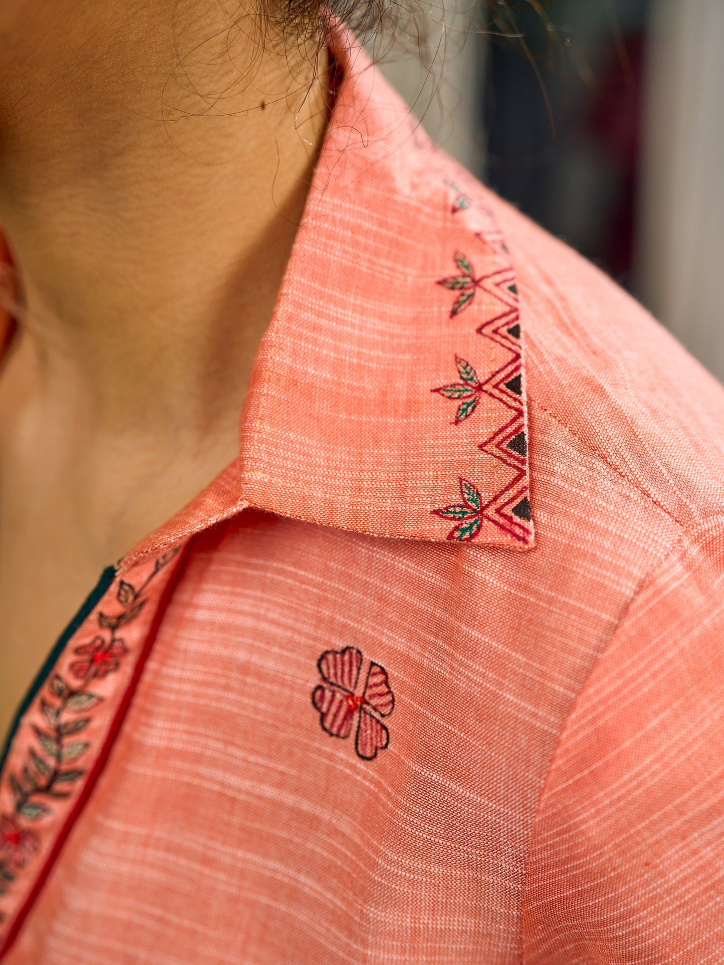 Peach dress featuring delicate Madhubani painting and graceful flared sleeves.