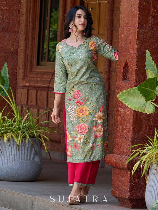 Soft green printed kurta with vibrant floral motifs, highlighted with hand embroidery and bright magenta accents.