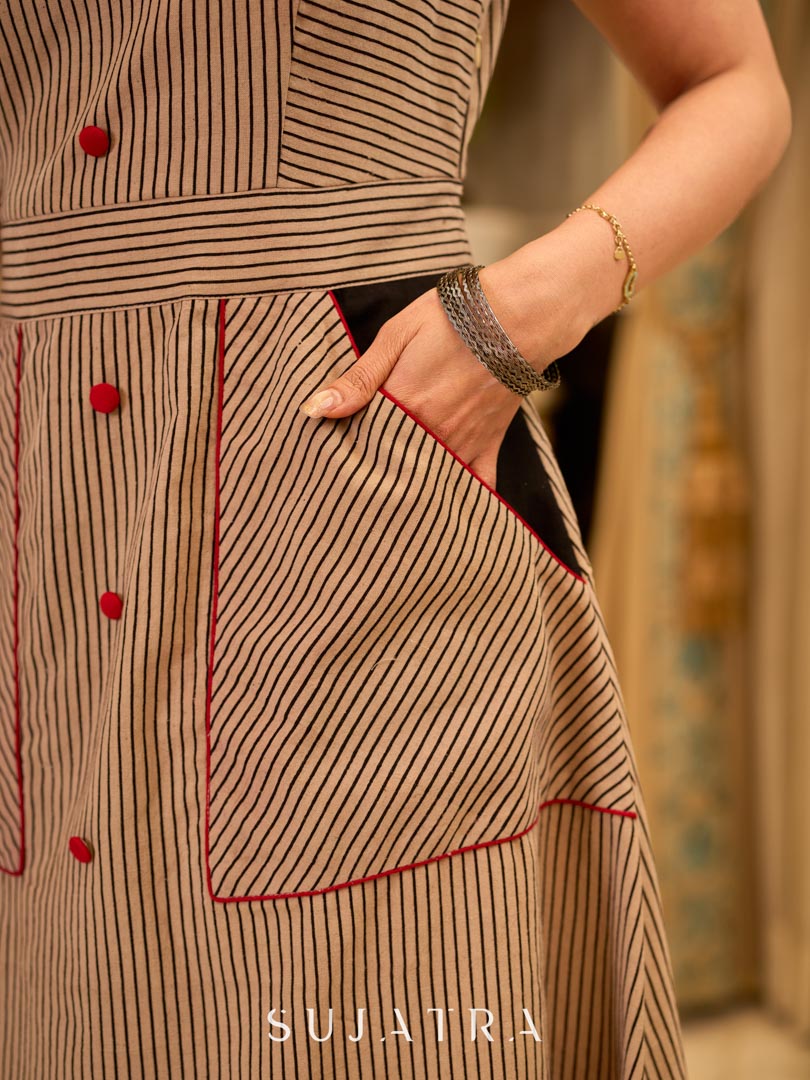 Statement Ajrakh striped dress designed sleeveless, accented with red details and convenient pockets