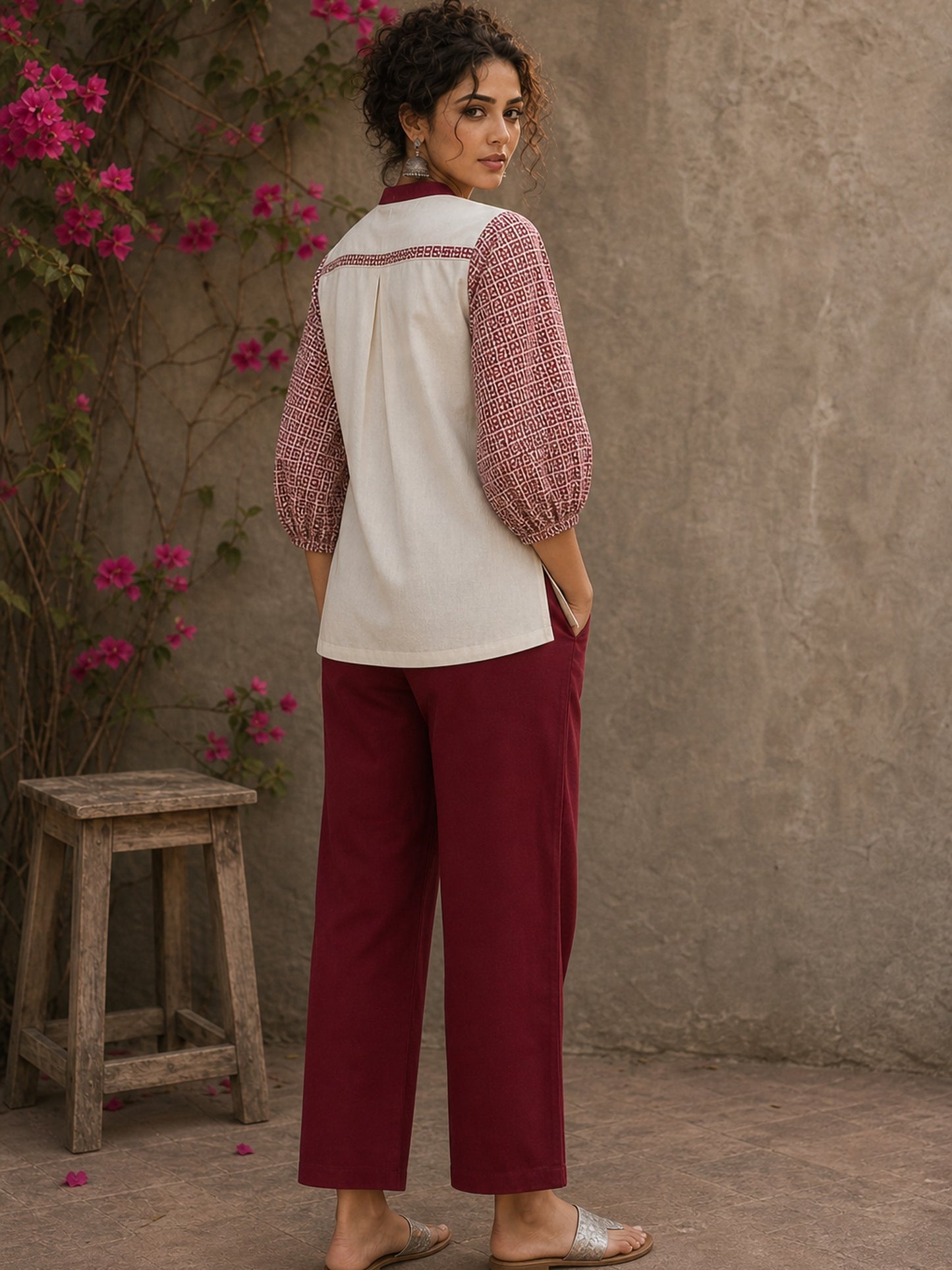 Chic off-white top featuring intricate hand block print sleeves in a vibrant red, complemented by a matching central decorative trim.