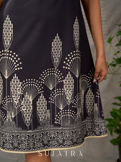 Black digital printed sleeveless dress with straight printed strip neckline and beige accents