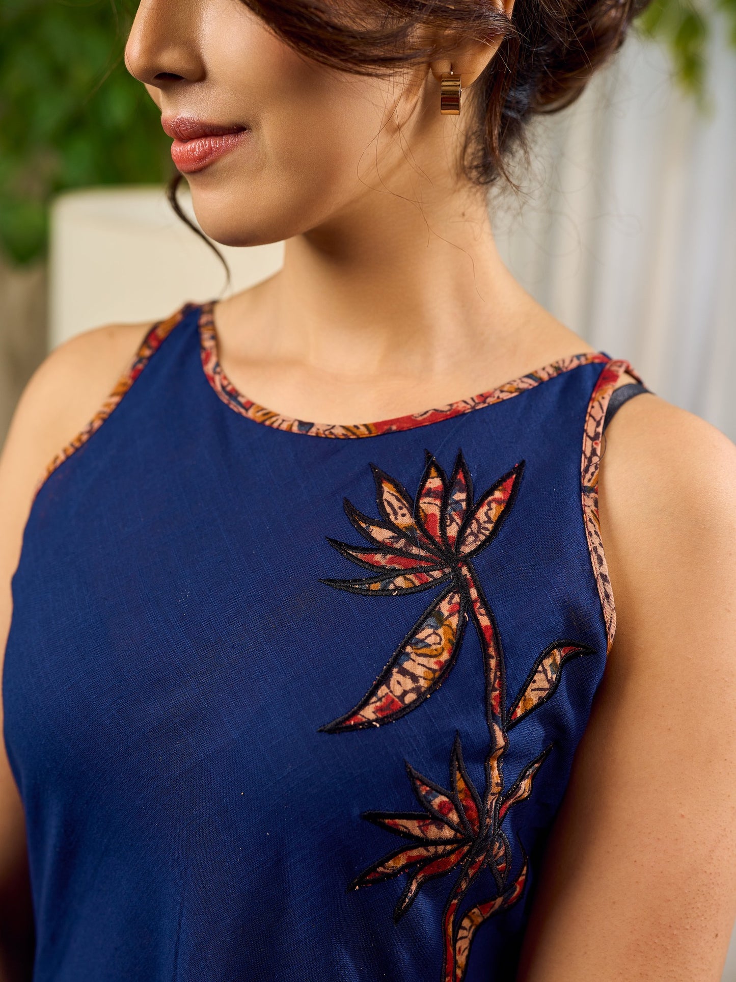 Modern navy dress enhanced by delicate, artistic Kalamkari side-applique work.