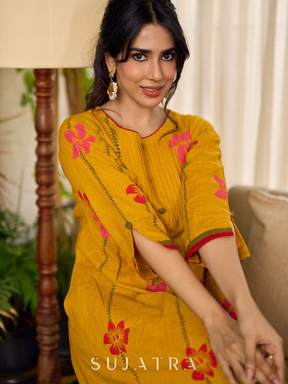 Mustard block printed pintuck dress with hand block red and pink vine floral motifs, accented with red and olive details for a rich, elegant look.