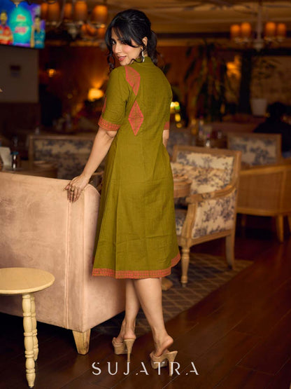 Gorgeous olive dress with pink abstract triangle hand block prints placed at the centre, sleeves, and back, featuring a mandarin collar and half sleeves for a refined, contemporary look.
