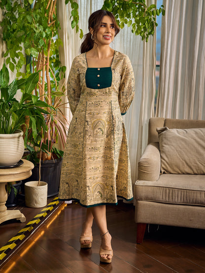 Artisanal beige Madhubani dress featuring intricate motifs, a contrasting green yoke, and refined accents.