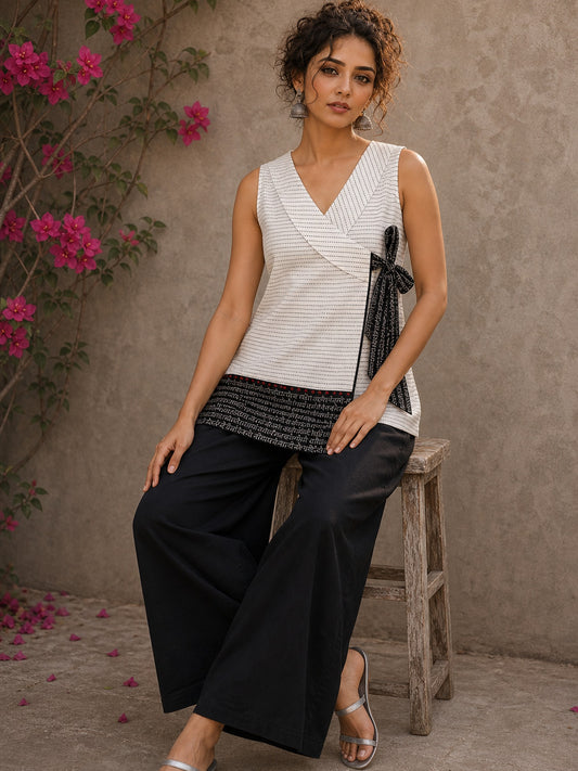White cotton wrap-style top featuring contrast block print mantra borders, side tie, and modern silhouette.