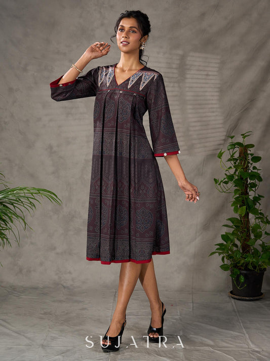 Black Ajrakh printed dress with pleats, maroon accents, and silver embellishments.