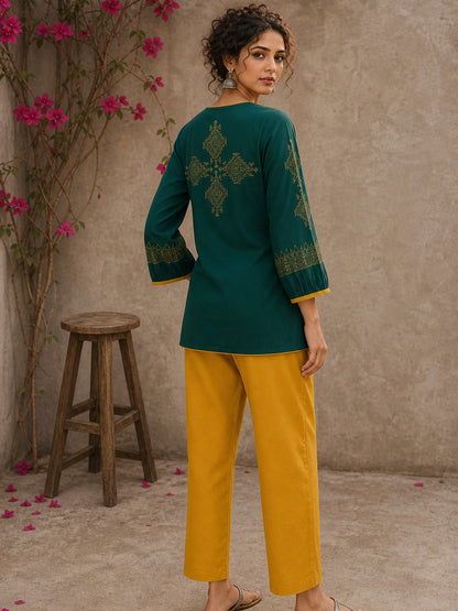Enchanting bottle green tunic featuring a refined, rhythmic Block print motifs, vibrant mustard accents, and a graceful aesthetic.